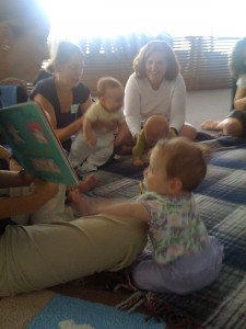 Abi cozying up to the faciliator as she reads a book to the group.