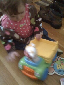 Abi plays with her first truck